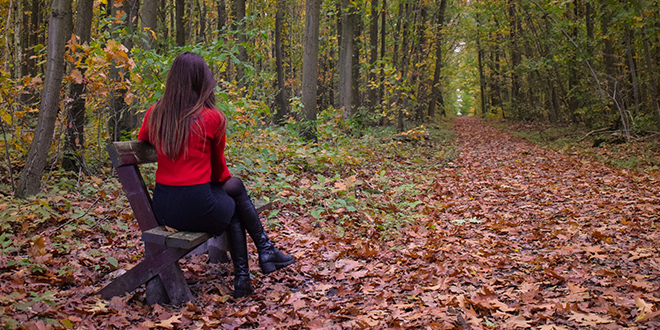 Јесен, девојка седи на клупи у шуми Јесен, девојка седи на клупи у шуми
